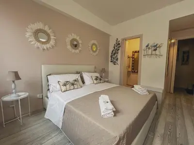 a bedroom with a large bed with towels on it at [jarase] nel centro di Palermo in Palermo