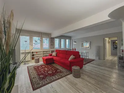 a living room with a red couch and a table at [jarase] nel centro di Palermo in Palermo