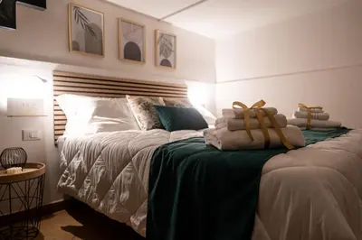 a bedroom with a bed with towels on it at Teama House - Appartamento in centro - Politeama in Palermo