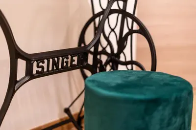 a black bench with a green cushion next to it at Teama House - Appartamento in centro - Politeama in Palermo
