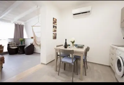 a room with a table and chairs in a kitchen at Holiday hause Vite Aerea in Terrasini
