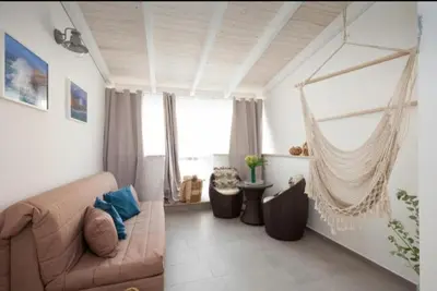 a living room with a couch and a hammock at Holiday hause Vite Aerea in Terrasini