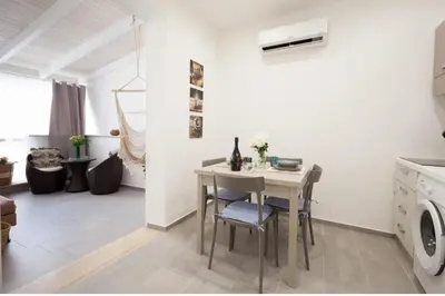 a kitchen with a table and chairs in a room at Holiday hause Vite Aerea in Terrasini