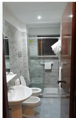 a bathroom with a toilet and a sink and a shower at Cleotto residence case vacanza in Palermo