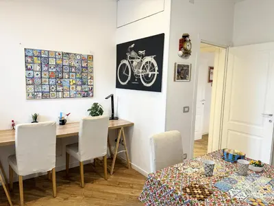 a dining room with a wooden table and a table and chairs at Lucky Home Palermo in Palermo