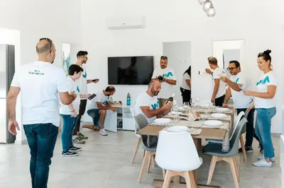 a group of people standing around a table at Villa Aurora in Balata di Baida