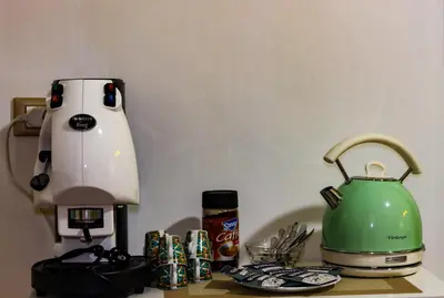 a counter with a coffee maker and a tea kettle at Alba e i Mori in Palermo