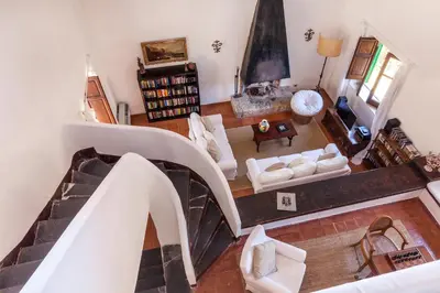 a view of a living room with a spiral staircase at Villa La Fenice by Wonderful Italy in Castellammare del Golfo