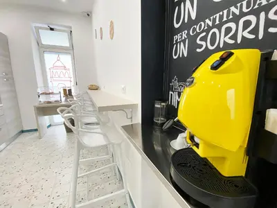 a kitchen with a yellow appliance sitting on a counter at Dimora Sicula Relais - Palermo in Palermo