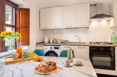 a kitchen with a table with a plate of food on it at Terrazza San Domenico in Palermo