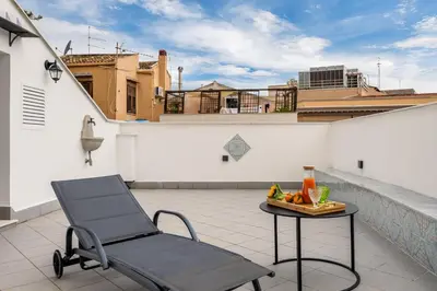 a chair and a table on the roof of a building at Terrazza San Domenico in Palermo