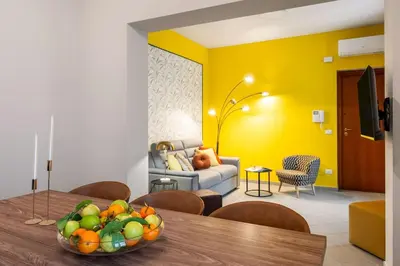 a living room with a table with a bowl of fruit at Terrazza San Domenico in Palermo