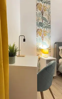 a room with a desk with a chair and a lamp at Merlo Holiday Homes Siviglia in Palermo