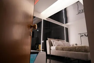 a bedroom with a bed with a black wall at Superior Suite Palermo in Palermo