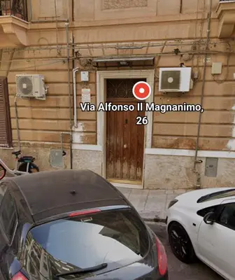 a white car parked in front of a building at Tati's Garden in Palermo