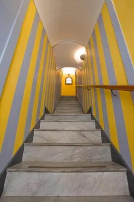 a staircase in a building with yellow and blue stripes at Sicilia Ovest - Domus Mariae Charming Apartments with Balcony in Castellammare del Golfo
