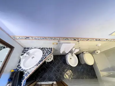 a bathroom with a sink and a toilet at Sicilia Ovest - Domus Mariae Charming Apartments with Balcony in Castellammare del Golfo