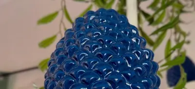 a blue vase filled with blue beads next to a plant at Donna Isabella a Ballarò in Palermo