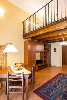 a kitchen and dining room with a table and a staircase at Hola House allo Spasimo in Palermo
