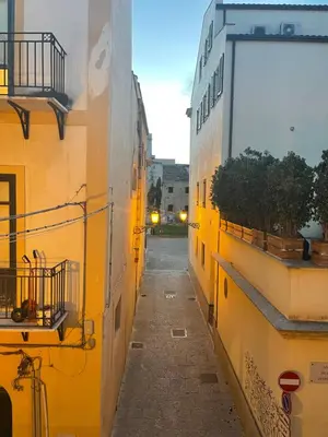 a narrow alley between buildings in a city at Hola House allo Spasimo in Palermo