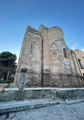 a building with a fence in front of it at Hola House allo Spasimo in Palermo