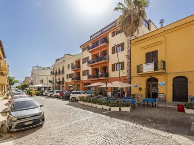 a street with cars parked next to a building at Apartment Sicilia by Interhome in Balestrate