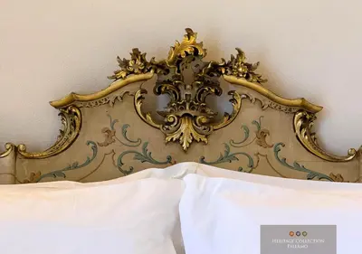 a gold headboard of a bed in a bedroom at Heritage Collection Palermo B&B in Palermo