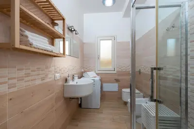 a bathroom with a sink and a toilet and a shower at I Tre Golfi - Villetta Ninfea in San Vito lo Capo