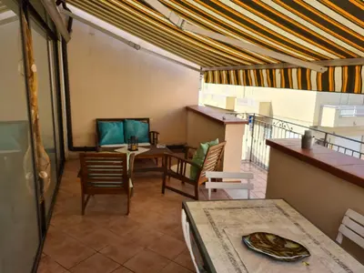 a room with a table and chairs and a balcony at Holiday House Giorgia in Terrasini