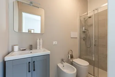 a bathroom with a sink and a toilet and a shower at Villetta Hilda by Wonderful Italy in Mondello