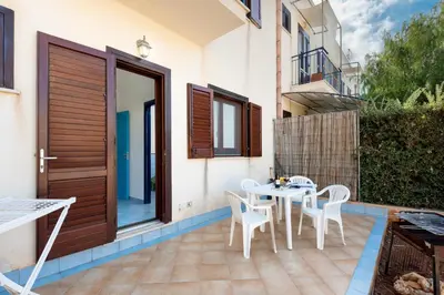a balcony with a table and chairs on a house at Paprica&Zenzero in San Vito lo Capo