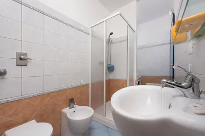 a bathroom with a sink and a toilet and a shower at Paprica&Zenzero in San Vito lo Capo