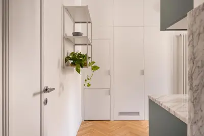 a kitchen with white cabinets and a potted plant at Casa Mirto a Piazza Marina by Wonderful Italy in Palermo