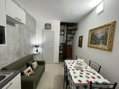 a living room with a table and a couch at Capobeb in Palermo