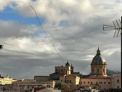 a kite flying in the sky over a city at Capobeb in Palermo