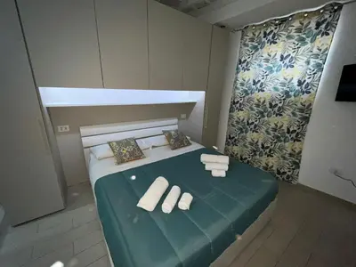 a small bedroom with a bed with two rolled towels at Capobeb in Palermo