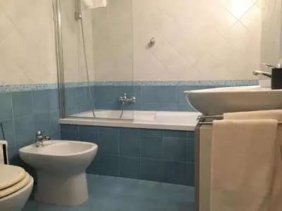 a bathroom with a toilet and a tub and a sink at La Fabbrica del Viceré in Palermo