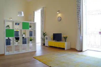 a living room with a tv and a white cabinet at La Fabbrica del Viceré in Palermo