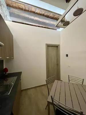 a kitchen with a table and chairs in a room at Baron’s Suites in Palermo