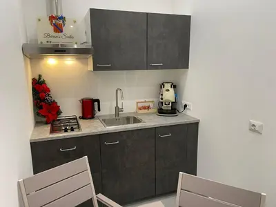 a kitchen with a sink and a counter top at Baron’s Suites in Palermo