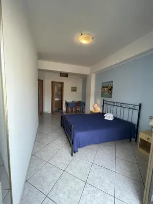 a bedroom with a blue bed in a room at Case Vacanza Trappetodavivere in Trappeto
