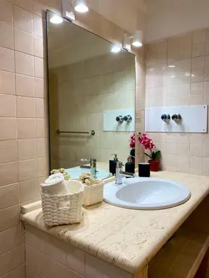 a bathroom with a sink and a large mirror at Urban poet retreat - casa di vincenzo e andrea 2 in Palermo