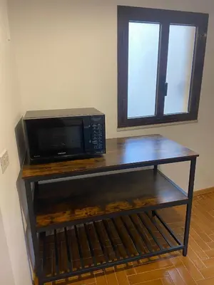 a microwave oven sitting on a table in a room at Cortile Cascino Home in Palermo