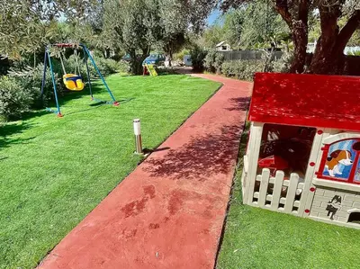 a playground with a dog house and a swing at Sicilian Shore Haven, 2 min to SEA in Terrasini