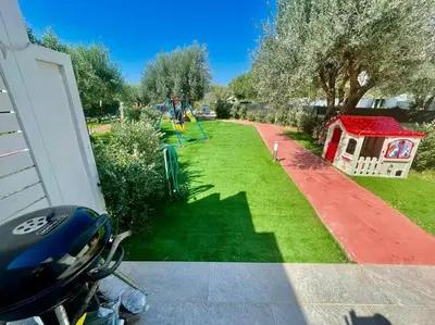 a view of a yard with a playground at Sicilian Shore Haven, 2 min to SEA in Terrasini