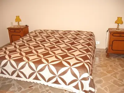 a bed in a bedroom with two night stands at Calatafimi Segesta -Casa vacanze Appartamento Garibaldi in Calatafimi