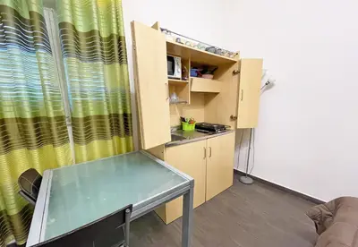 a small room with a table and a yellow curtain at Monfenera Little Apartments in Palermo