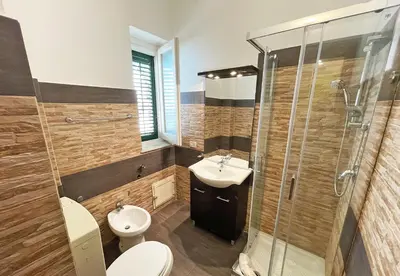 a bathroom with a toilet and a sink and a shower at Monfenera Little Apartments in Palermo
