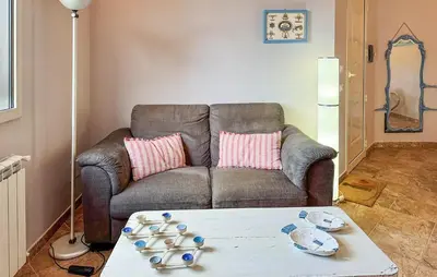 a living room with a couch and a table at Beautiful Home In Altavilla Milicia in Altavilla Milicia
