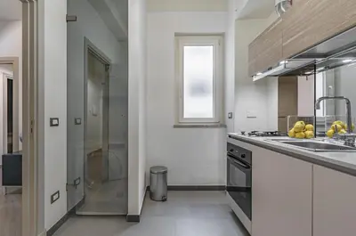 a kitchen with a sink and a stove top oven at GuestHost - Al Qasr Design and Luxury Flat - Palermo Center in Palermo